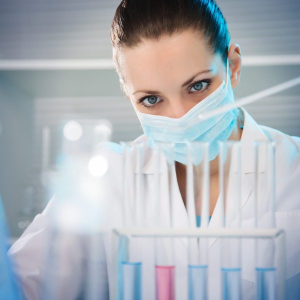 Attractive young female scientist working in laboratory